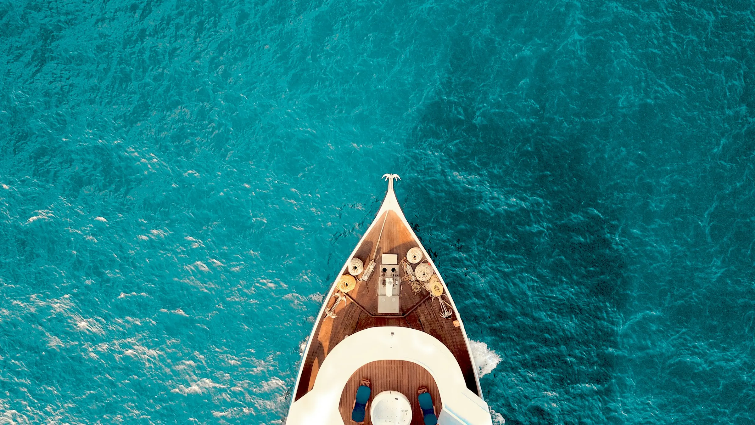 Aerial view of a small boat on clear blue water
